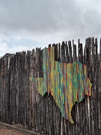 Art on the back fence near the firepit