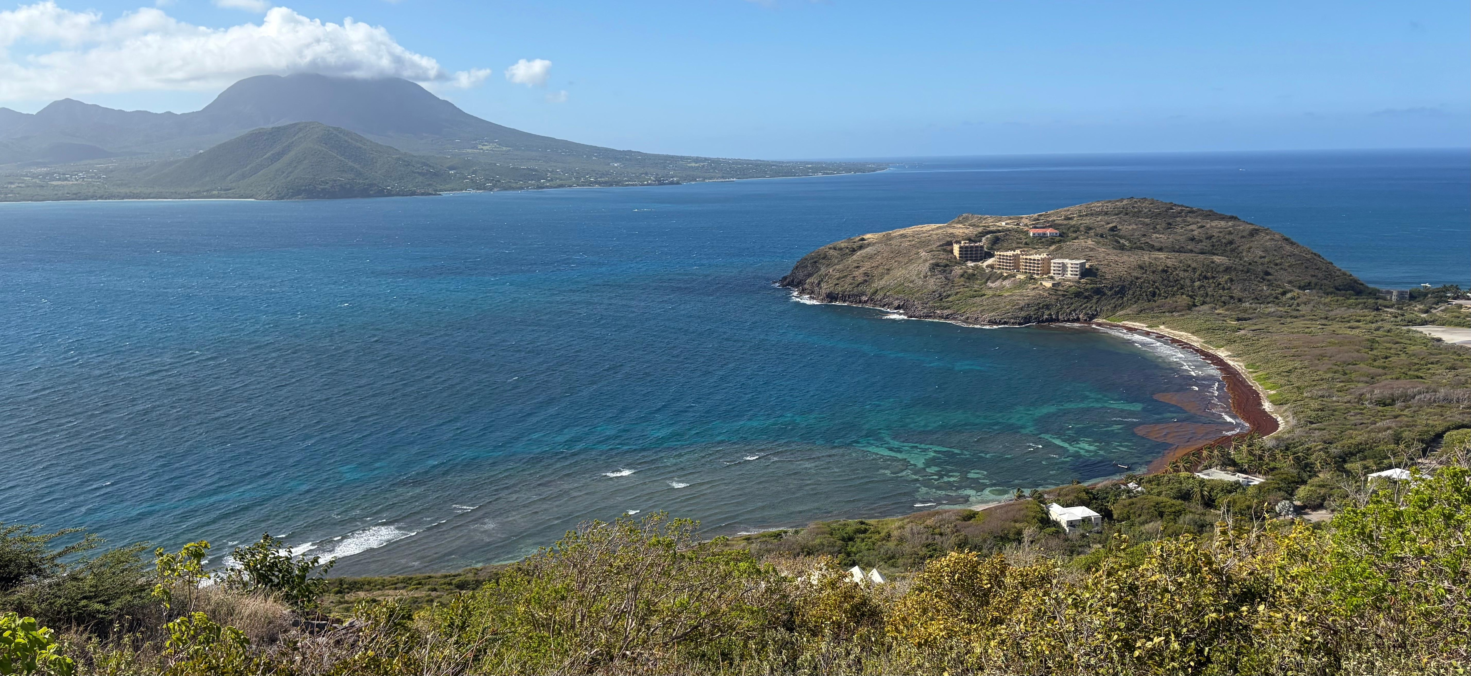 View from St. Anthony’s hill behind the house, which is the white roofs right by the water.