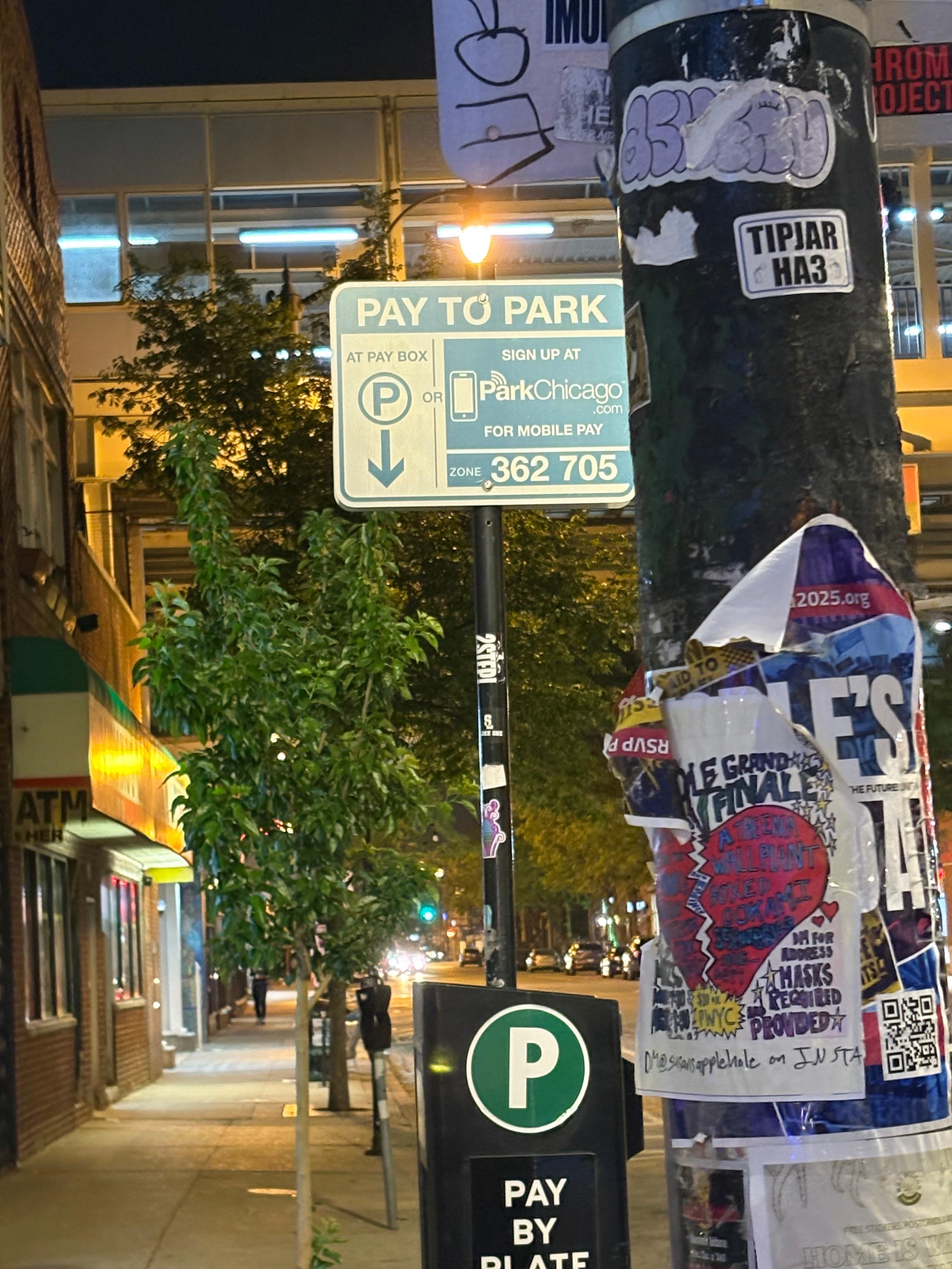 The Chicago Park app/sign to pay to park out front of this place. Also notice the other signs about street cleaning and resident permits.