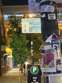 The Chicago Park app/sign to pay to park out front of this place. Also notice the other signs about street cleaning and resident permits.
