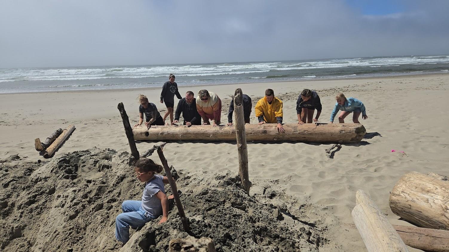 We found a very large log and rolled in down the beach to make a wind block.  It was really fun to work together.

