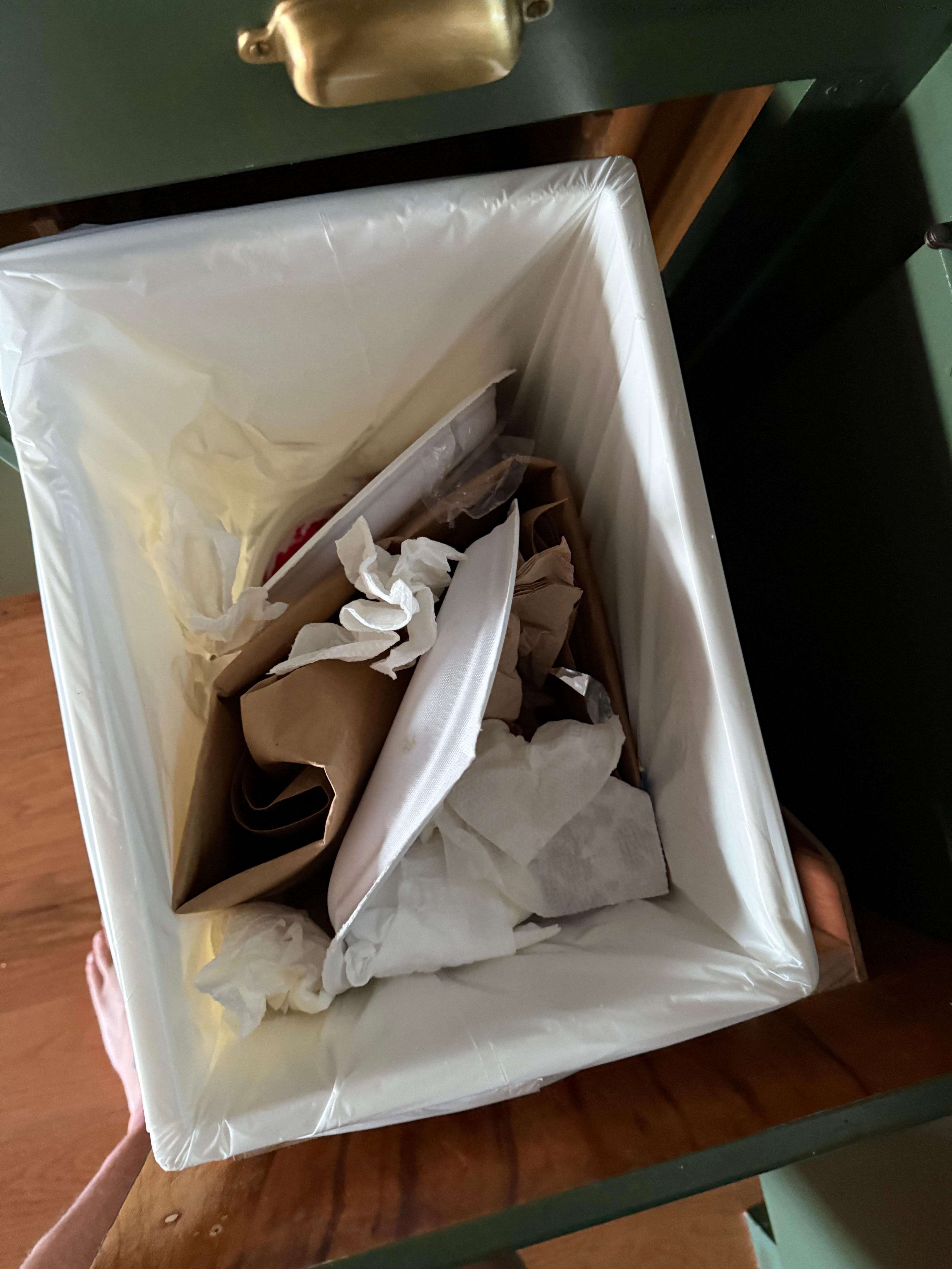 Trash was completely full with noticeable food remnants.