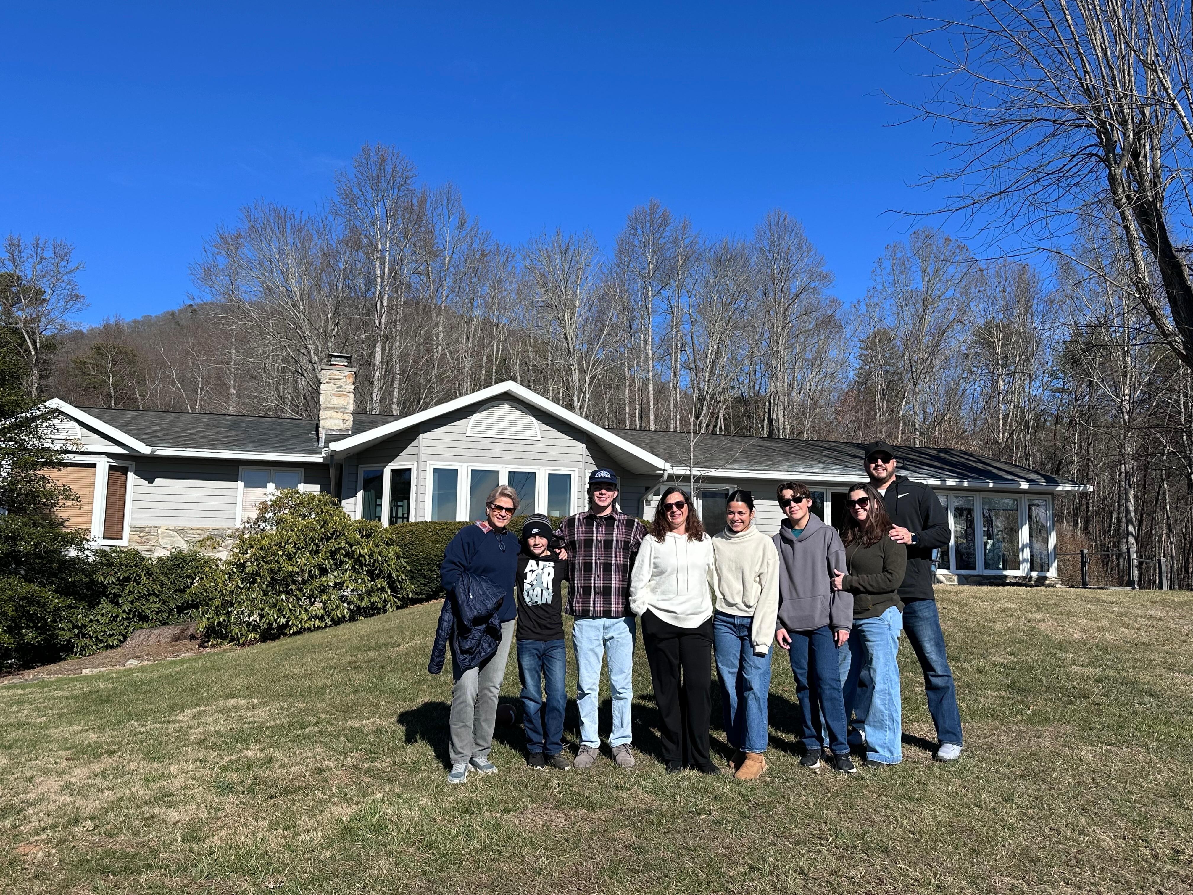 My family with the house in the background.