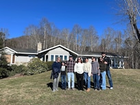 My family with the house in the background.