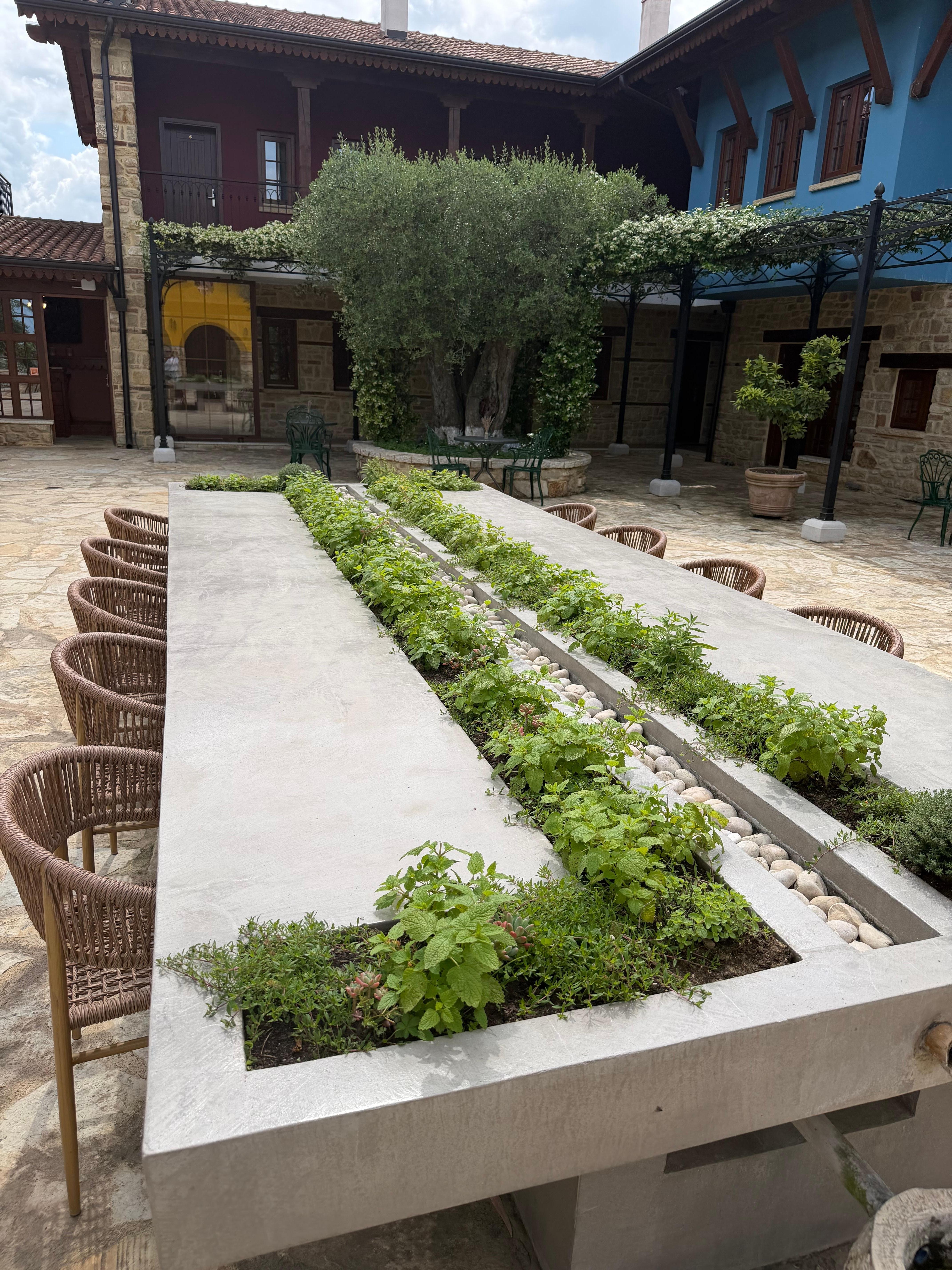 Table with herb garden & center stream fountain 
