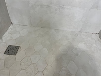 Orange and black stains on shower floor!