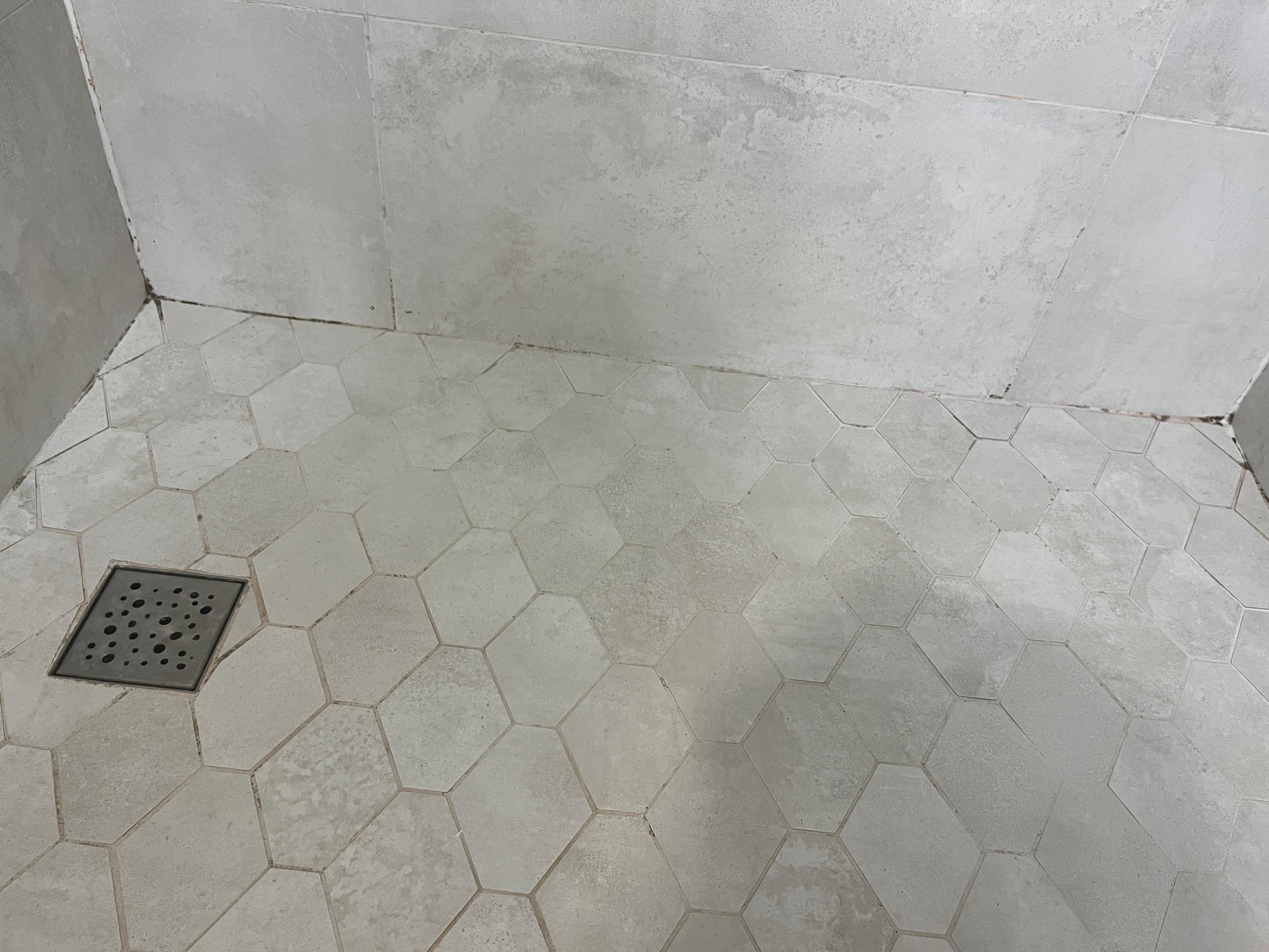 Orange and black stains on shower floor!