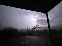 View of a thunderstorm over the mountains seen from the patio.