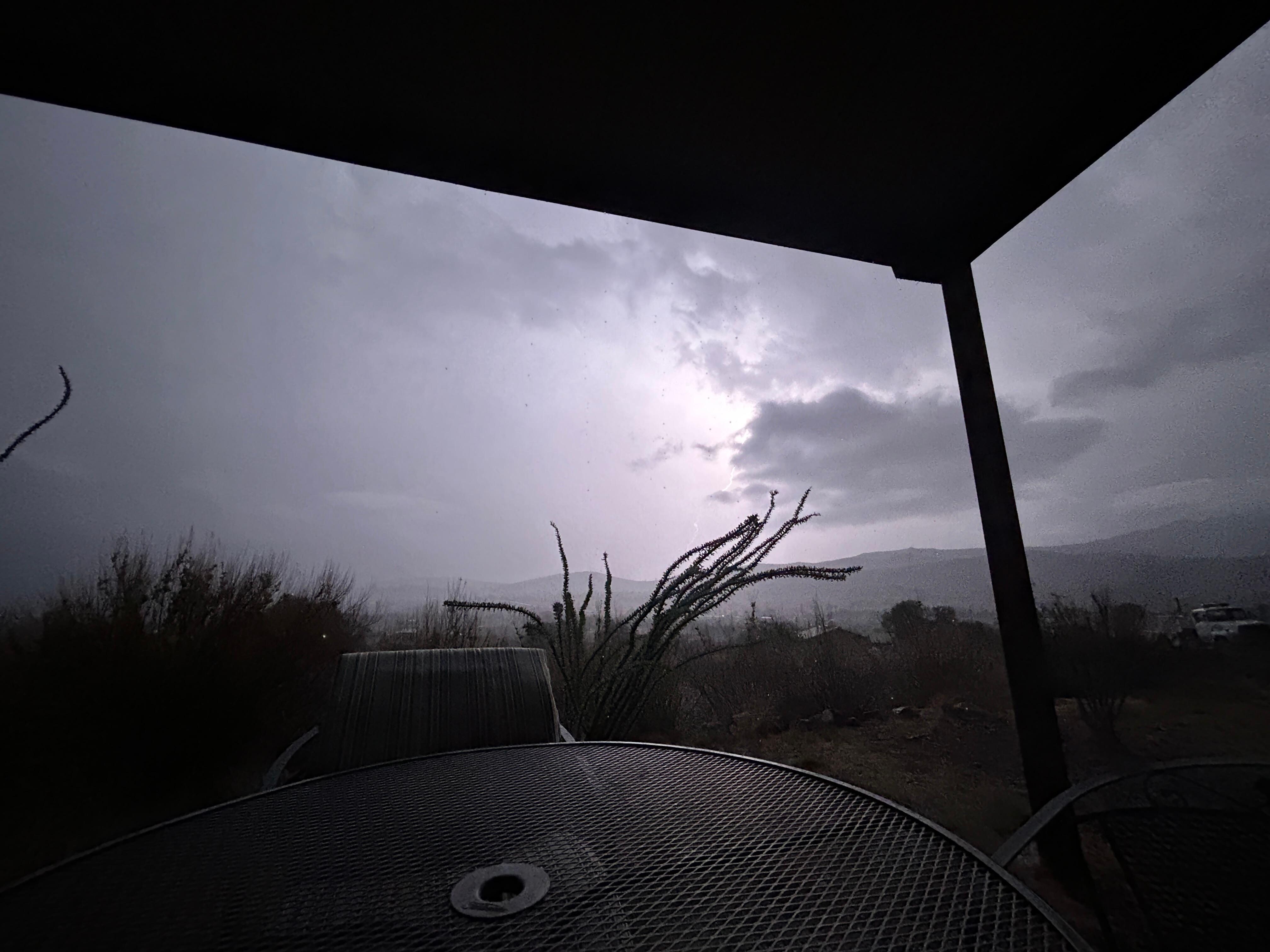 View of a thunderstorm over the mountains seen from the patio.