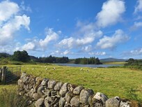 View of house and lake from down the lane