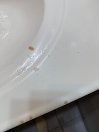 Bathroom sink, covered in cigarette burns. When you turn the sink on, the smell cigarette smoke assaults you.