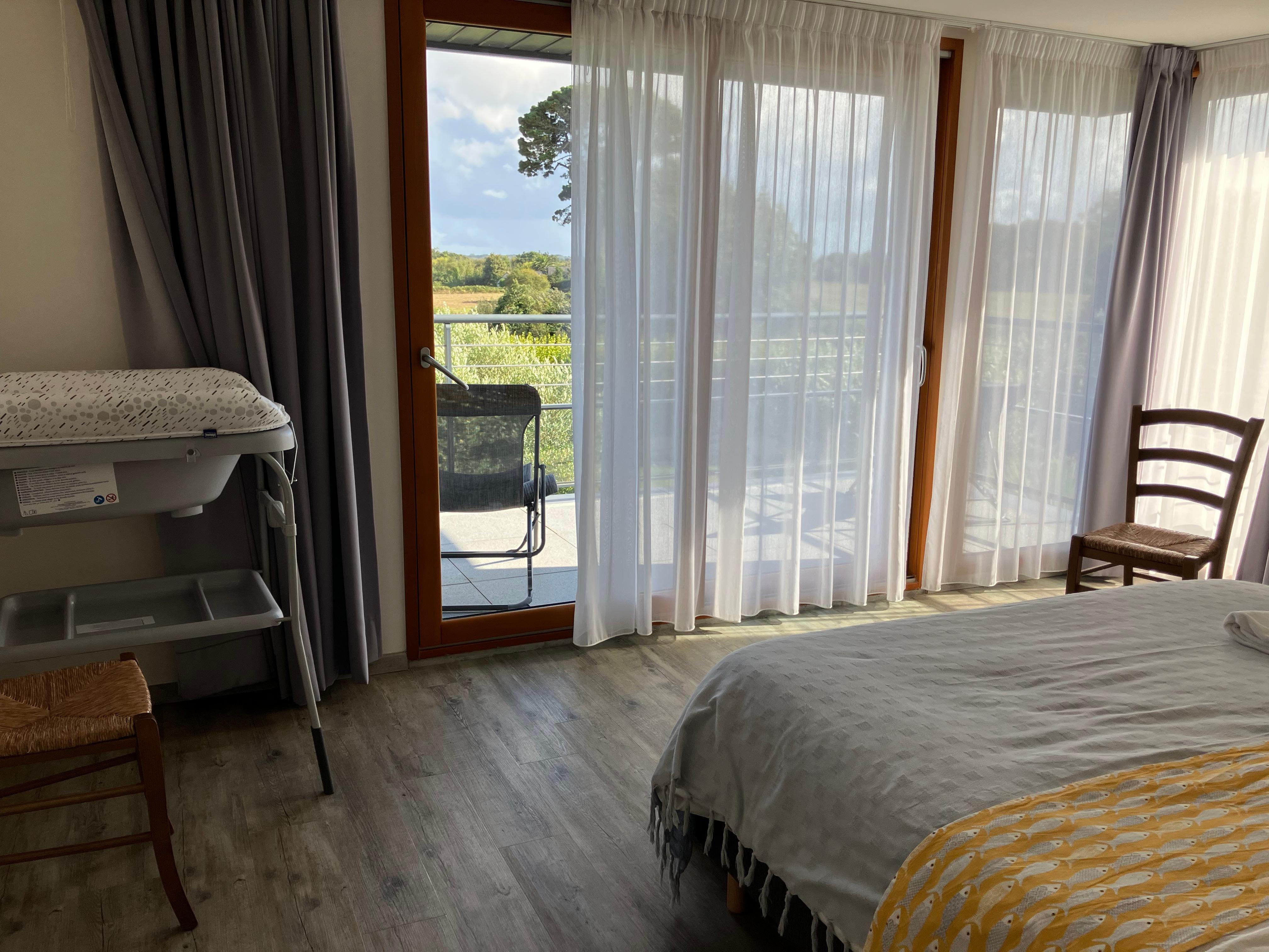 Bedroom with balcony and countryside views
