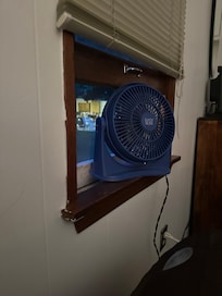 Window at the foot of the bed. Luckily we had a small fan to add privacy and air flow.