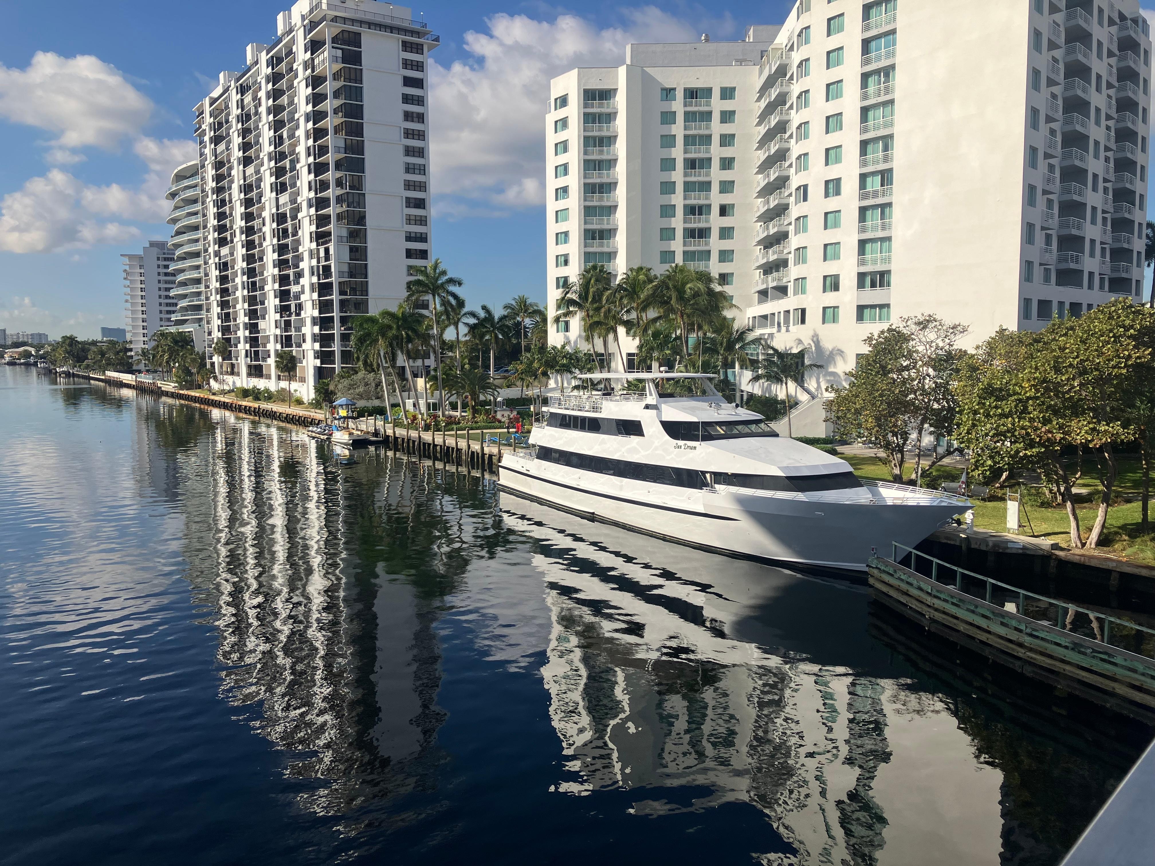 Yacht moored outside hotel, image taken from bridge