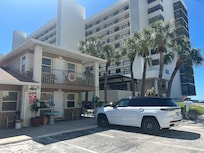 See the tall building? THAT is beachfront. THAT has a beachfront penthouse. The VRBO "Beachfront Penthouse" is the tiny second floor converted motel room on a busy road.