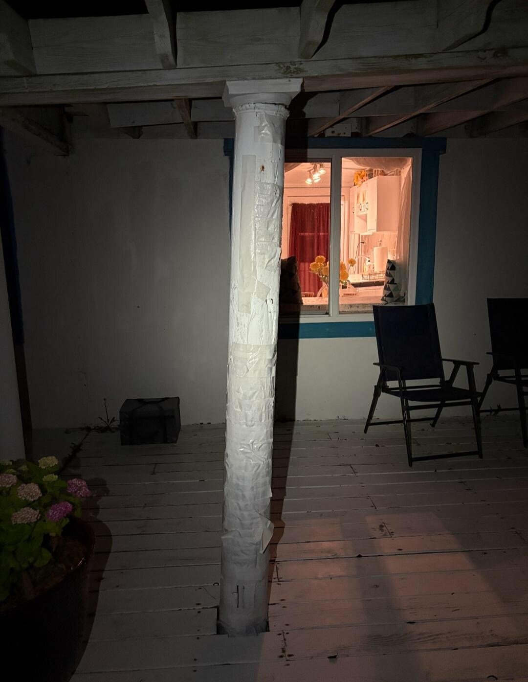 Rotted post that has been painted and taped