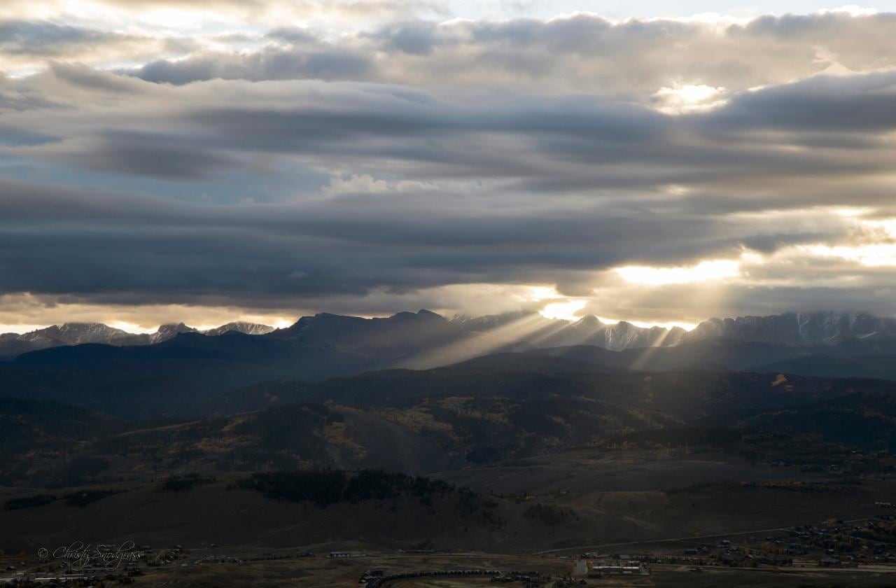 Beautiful fall sunrise beams over continental divide shining down on the south end of Granby from cabin deck.