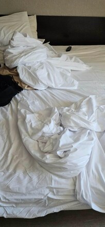 Only sheets and no comforter on bed.