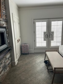 Room showing fireplace and balcony