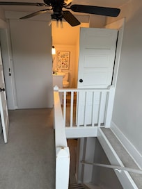 Upstairs half bath has plywood barn door and is not very private between bedroom at top of steep stair.