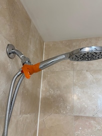 Broken shower hose held by tape.