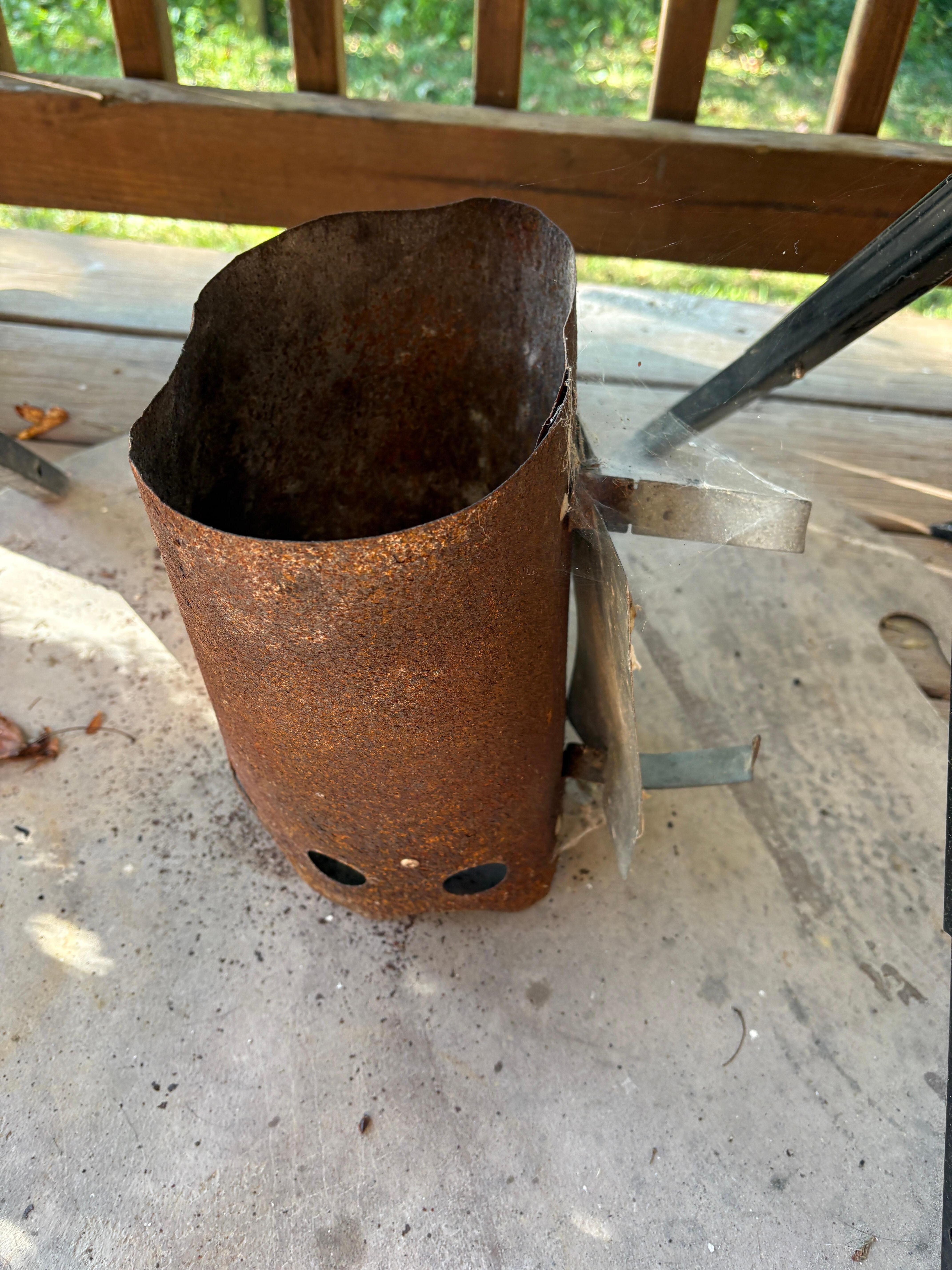 Broken rusted charcoal holder 