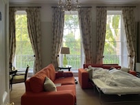 Living room sofa bed set up in Virginia Woolf suite.