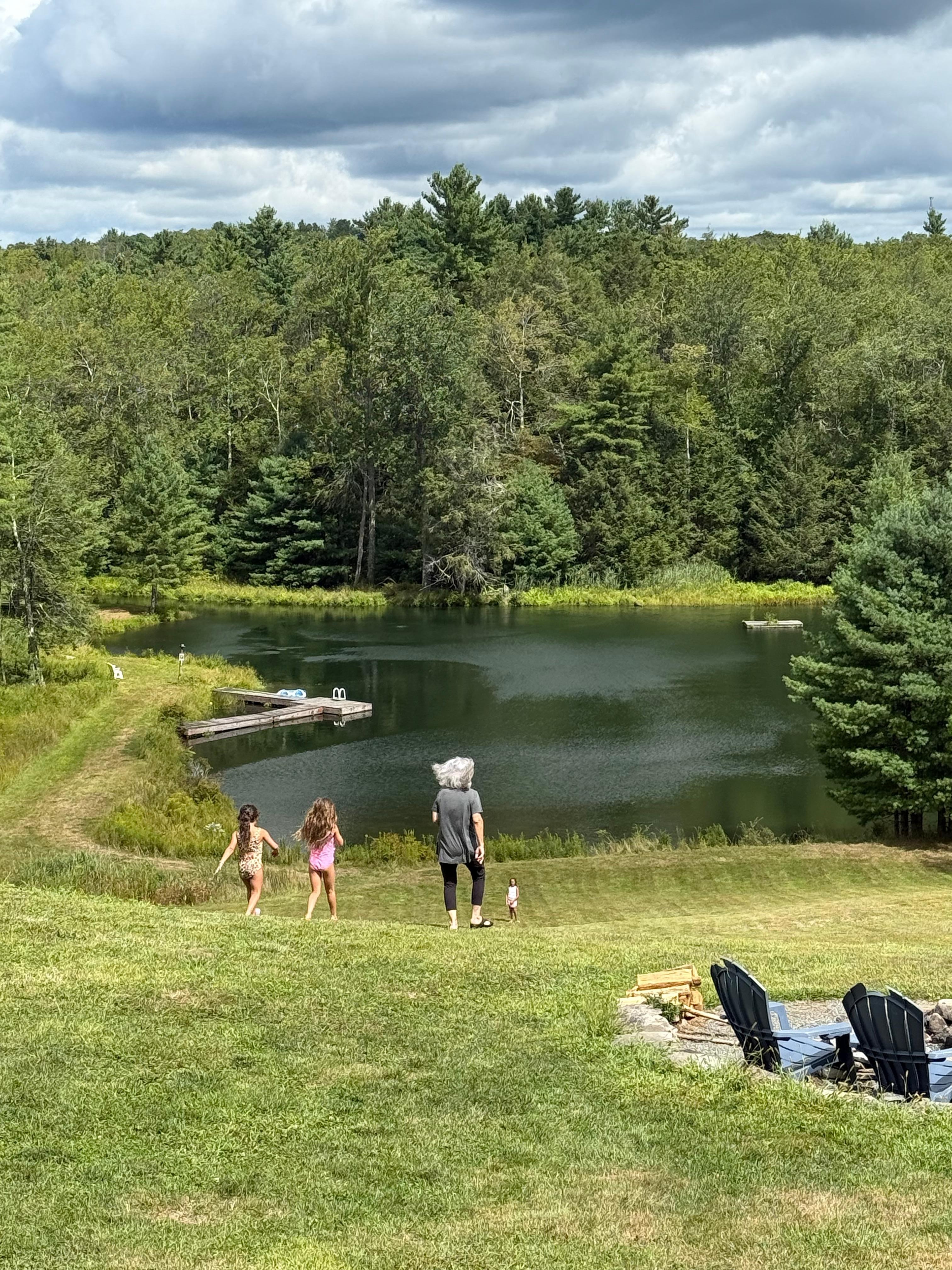 Walking to lake to paddle boat and fish. 