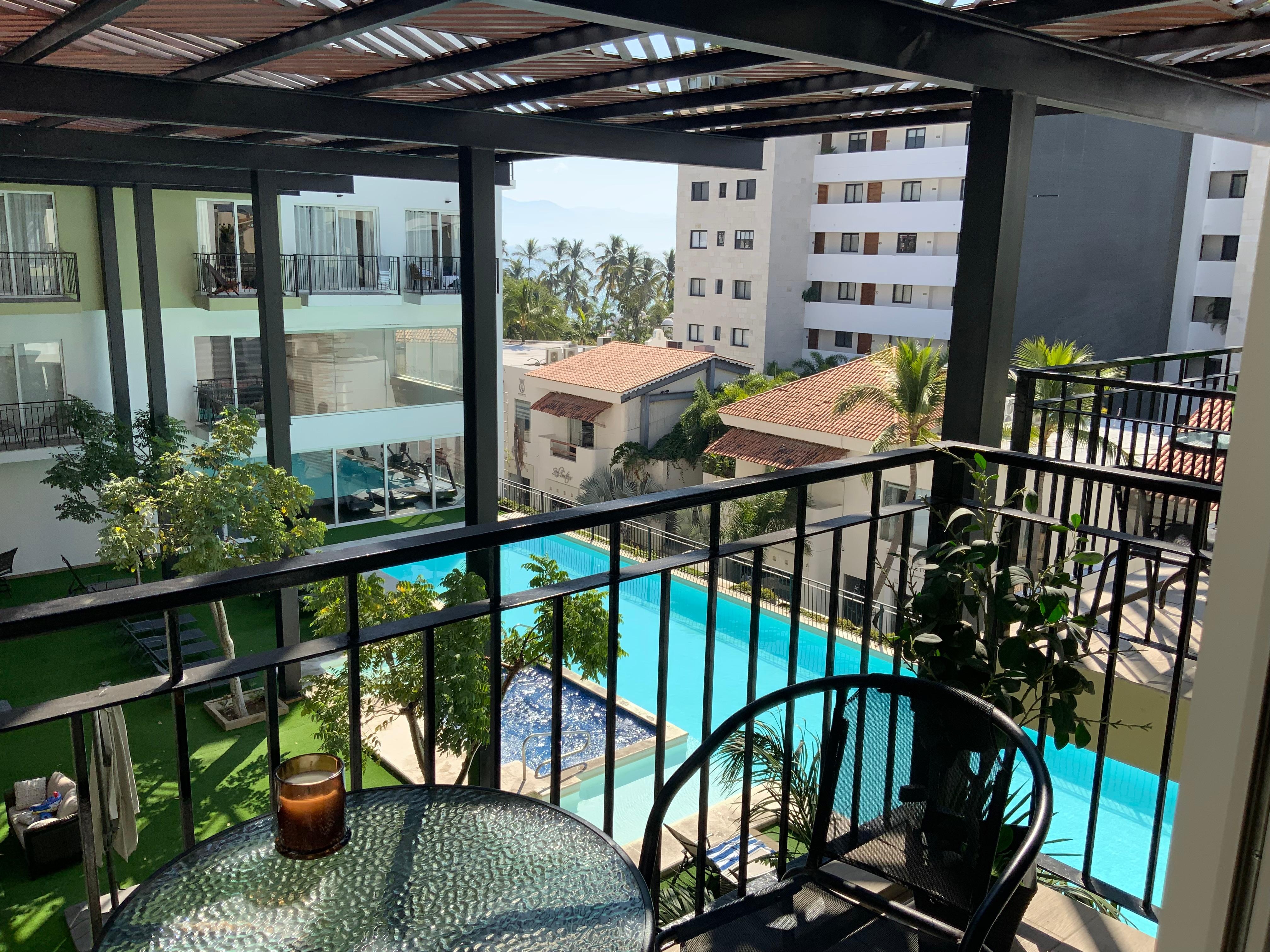 From the unit looking down at the pool area. Peekaboo view of the ocean beyond