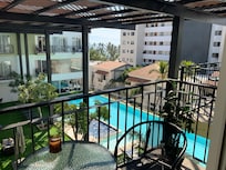 From the unit looking down at the pool area. Peekaboo view of the ocean beyond