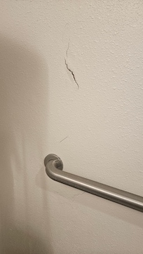 Cracked wall near toilet