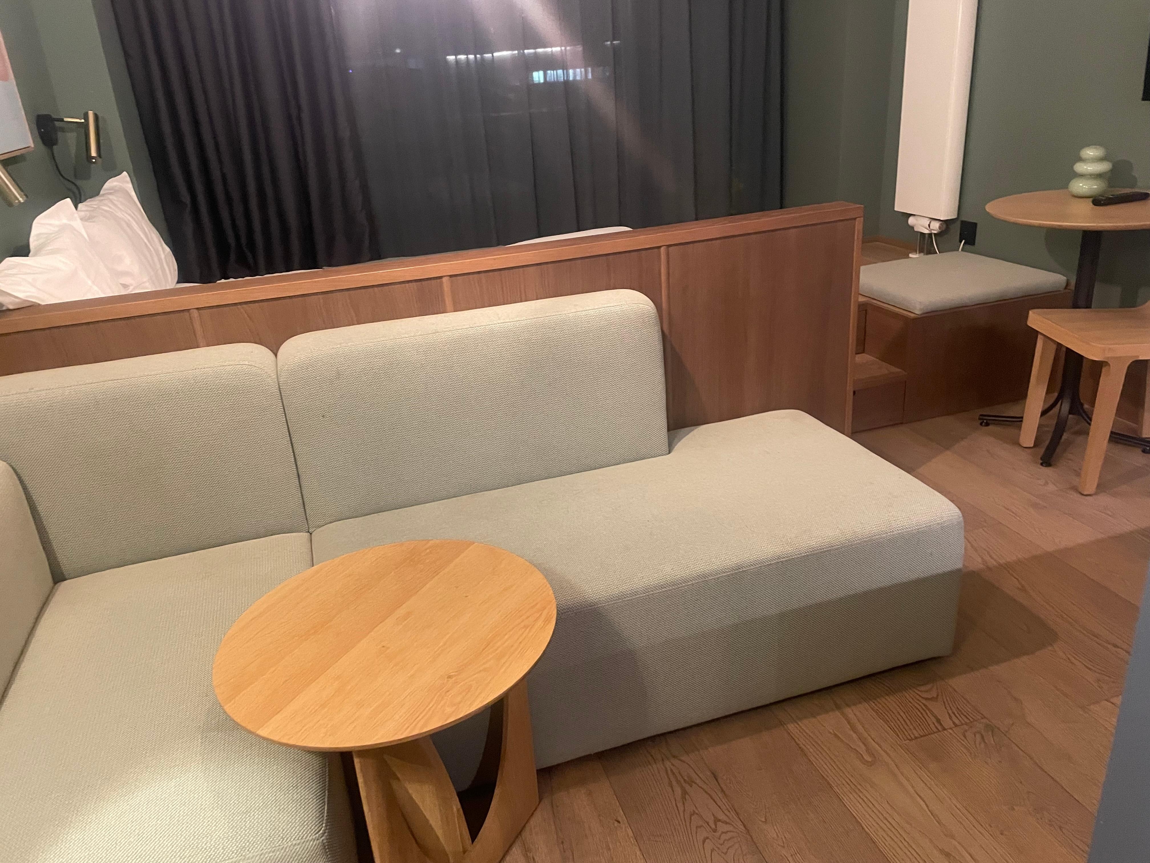 Bed is on platform behind sofa unit