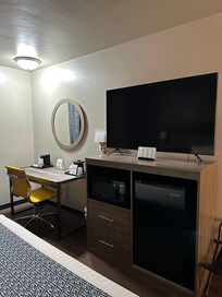 Desk and tv and fridge