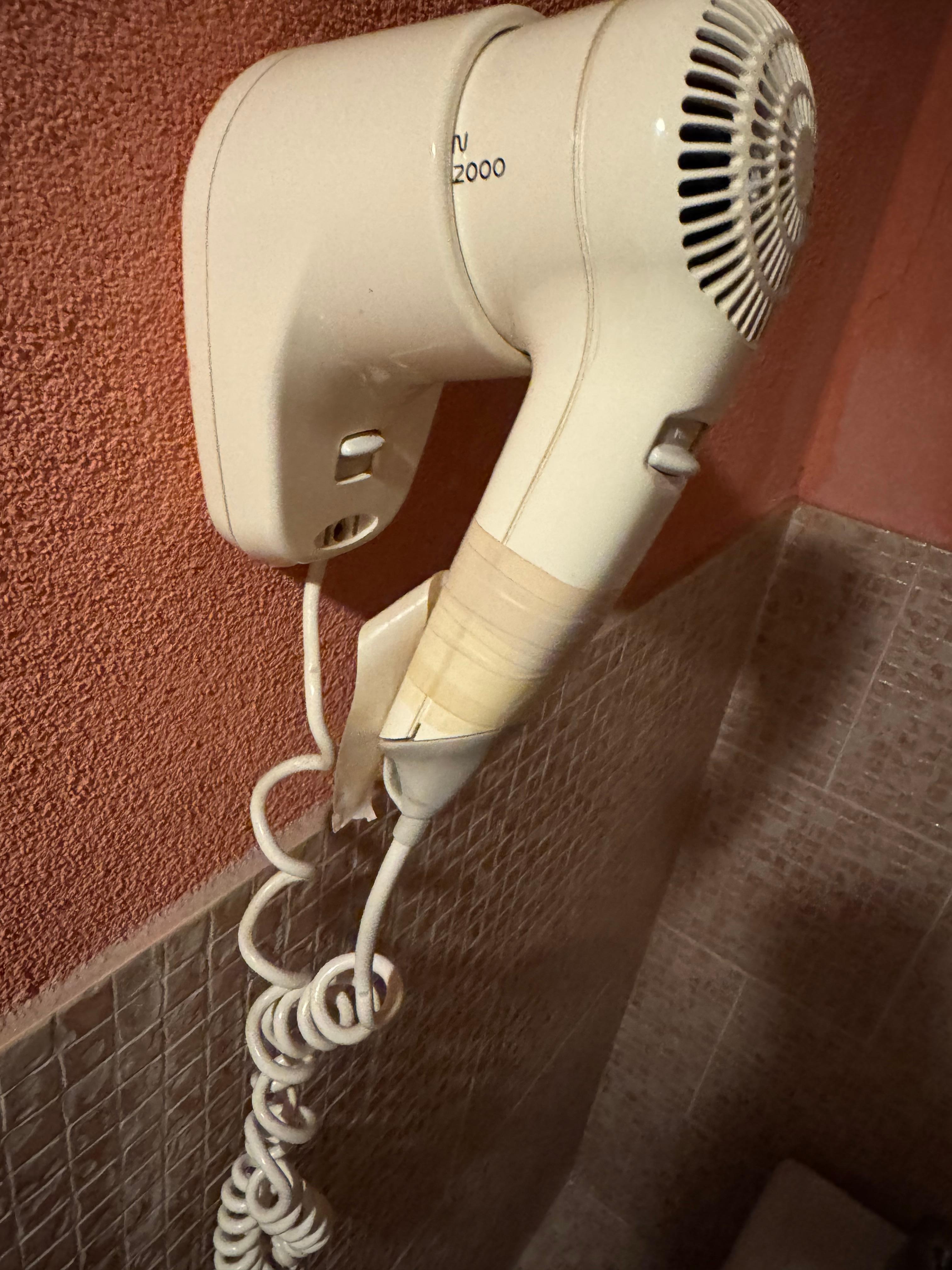 Professional repair of the hairdryer with masking tape 