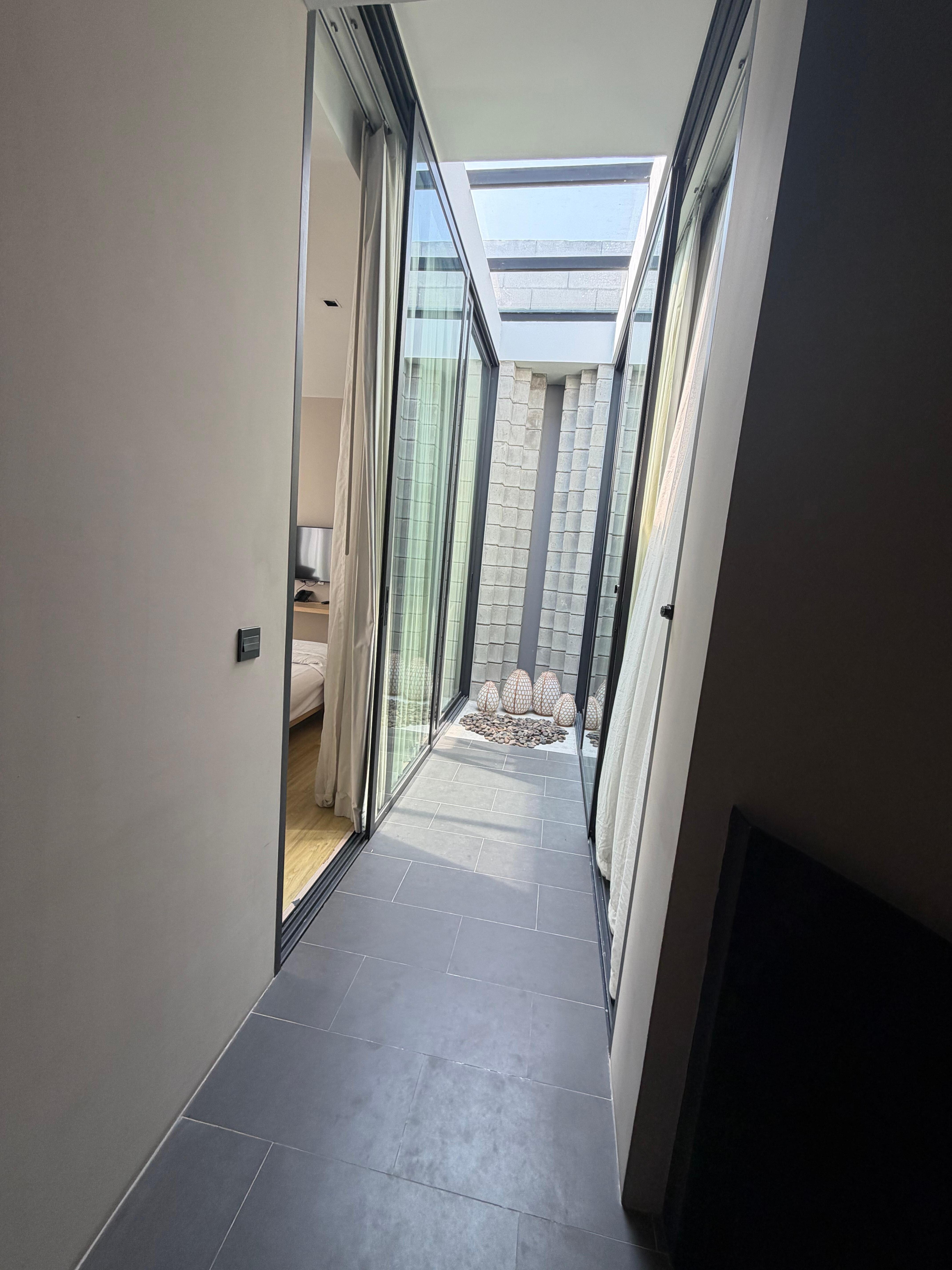 2 Bedroom hall with sliding doors and skylights. 