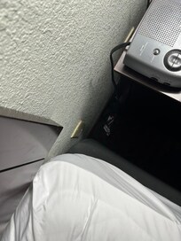 Trash - candy wrappers next to night stand