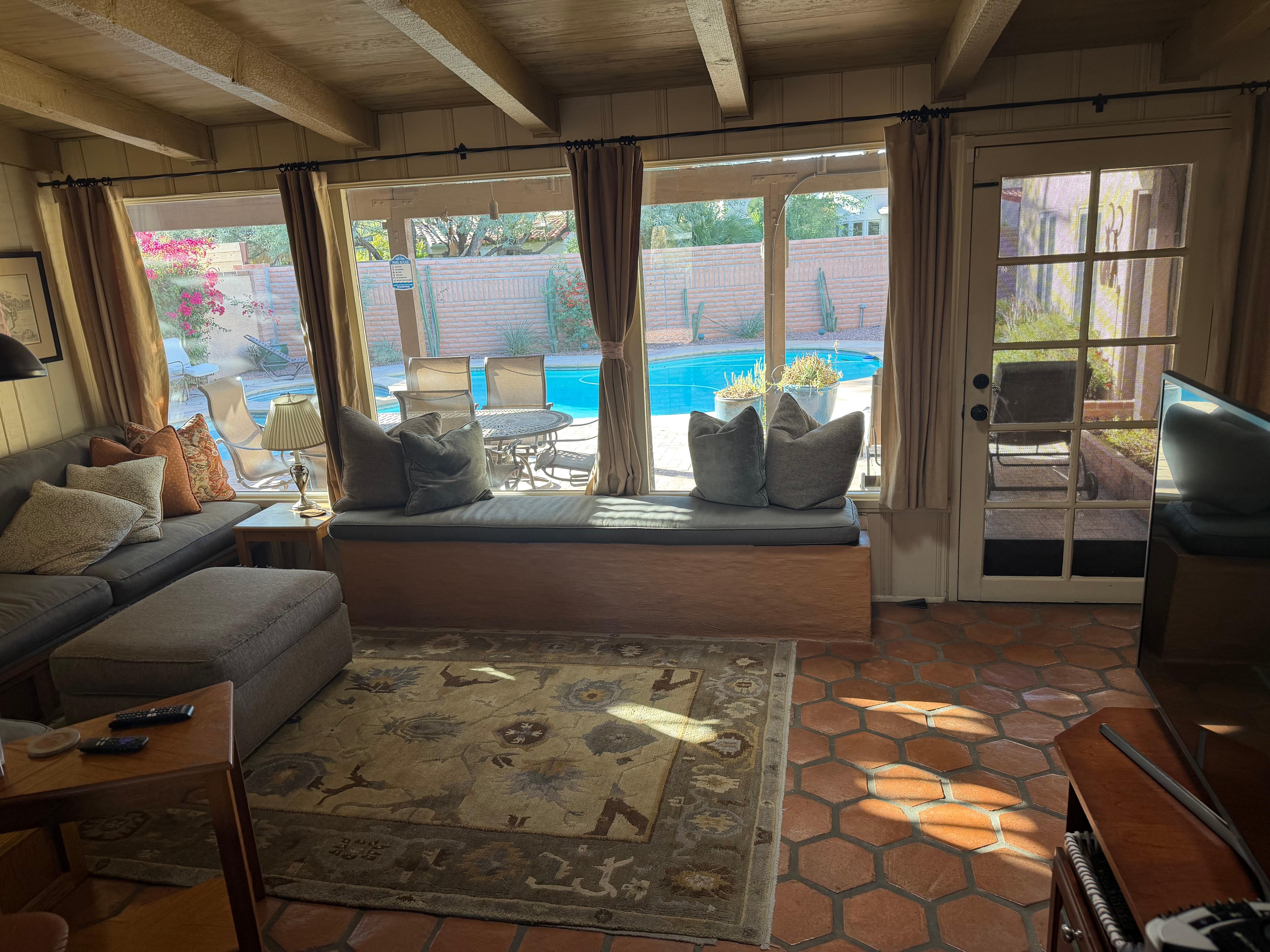 TV area looking out over patio and pool