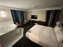 King room with one person jacuzzi tub in the bedroom area. This room has no “living room” or couch.