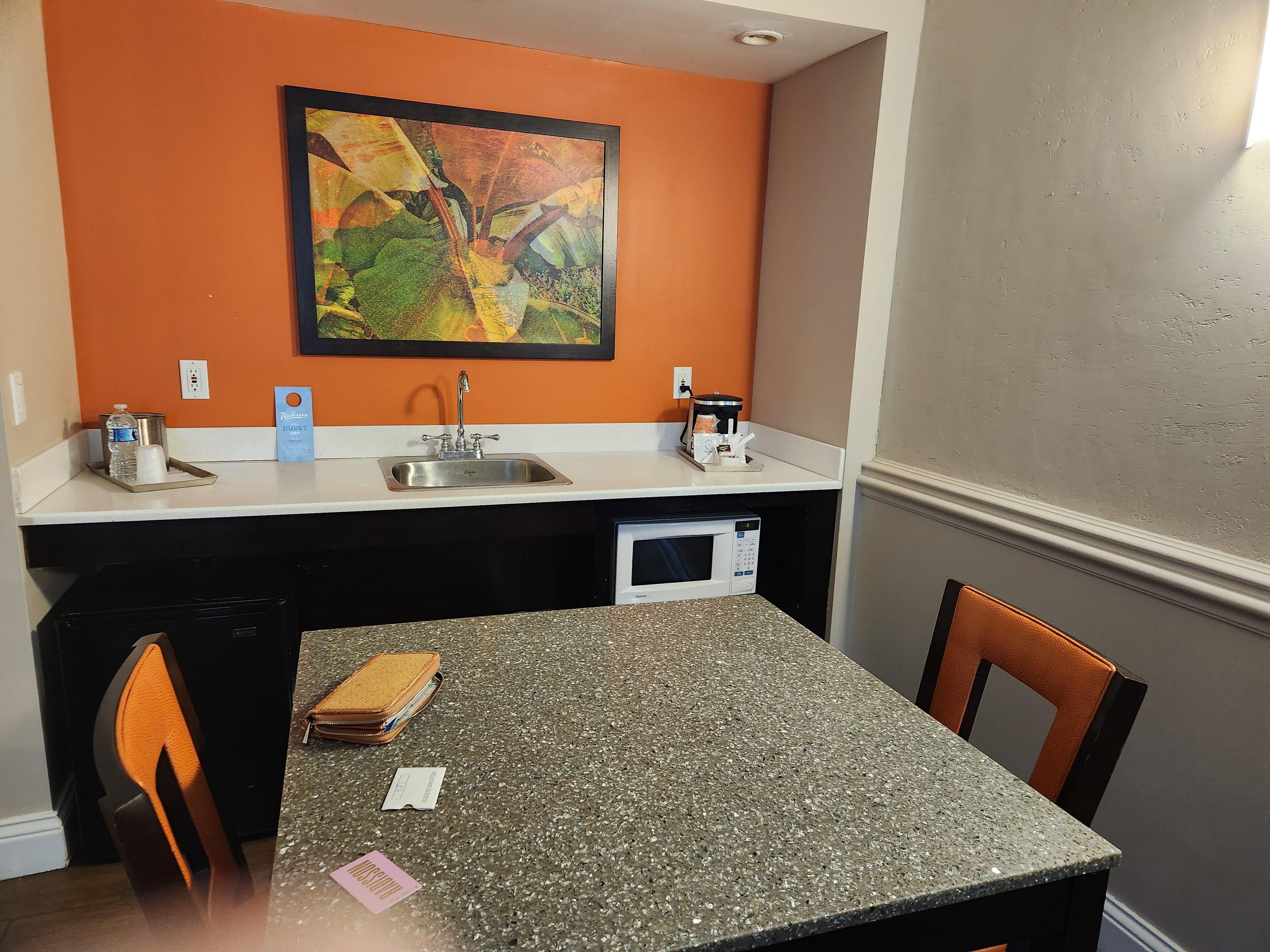 Kitchen with fridge and microwave. 