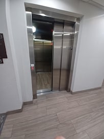 Photo of elevator broken and sitting on 3rd floor