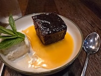 Delicious sticky brownie with ice cream and coffee sauce