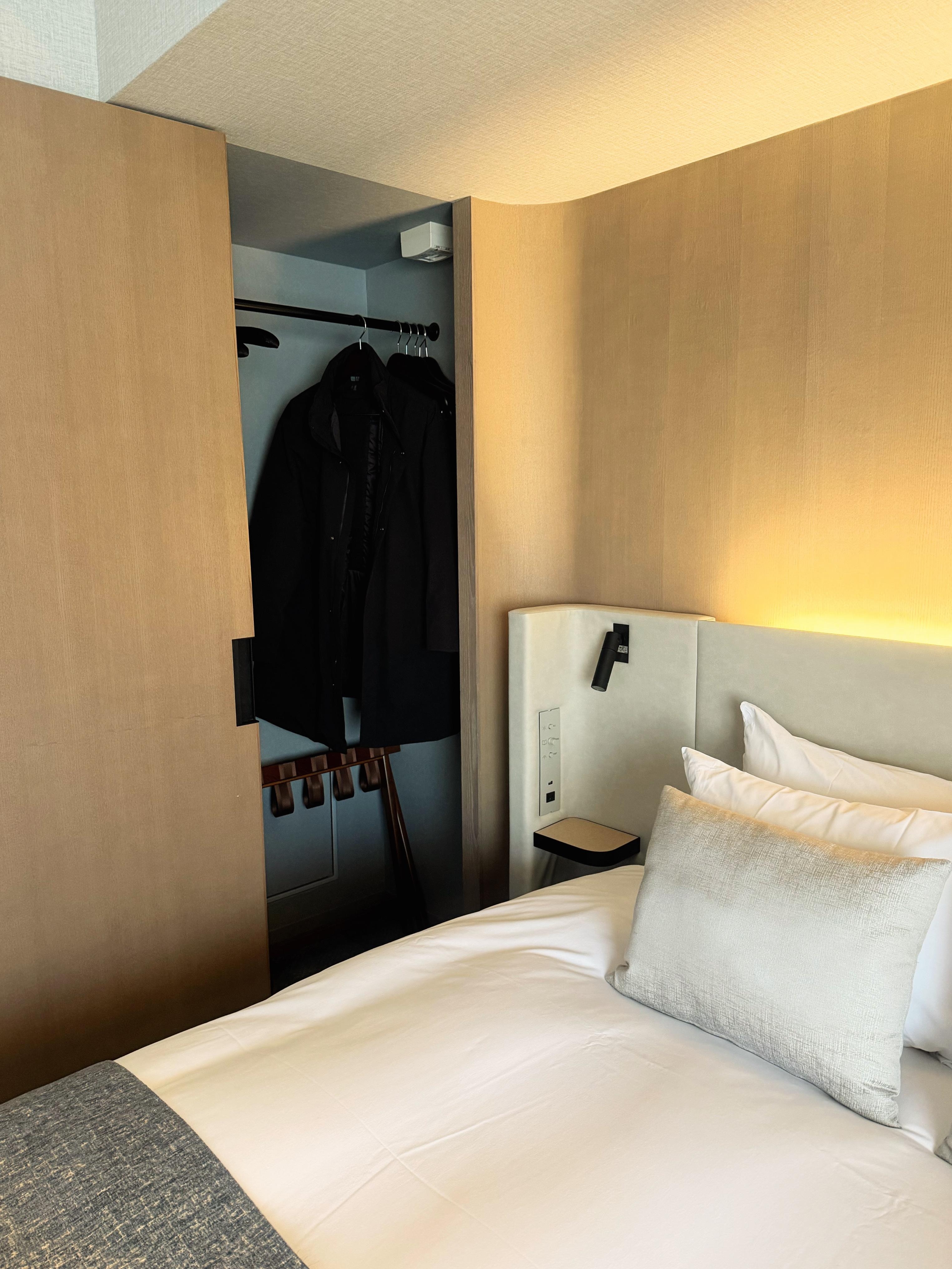 Bedside clothes closet.