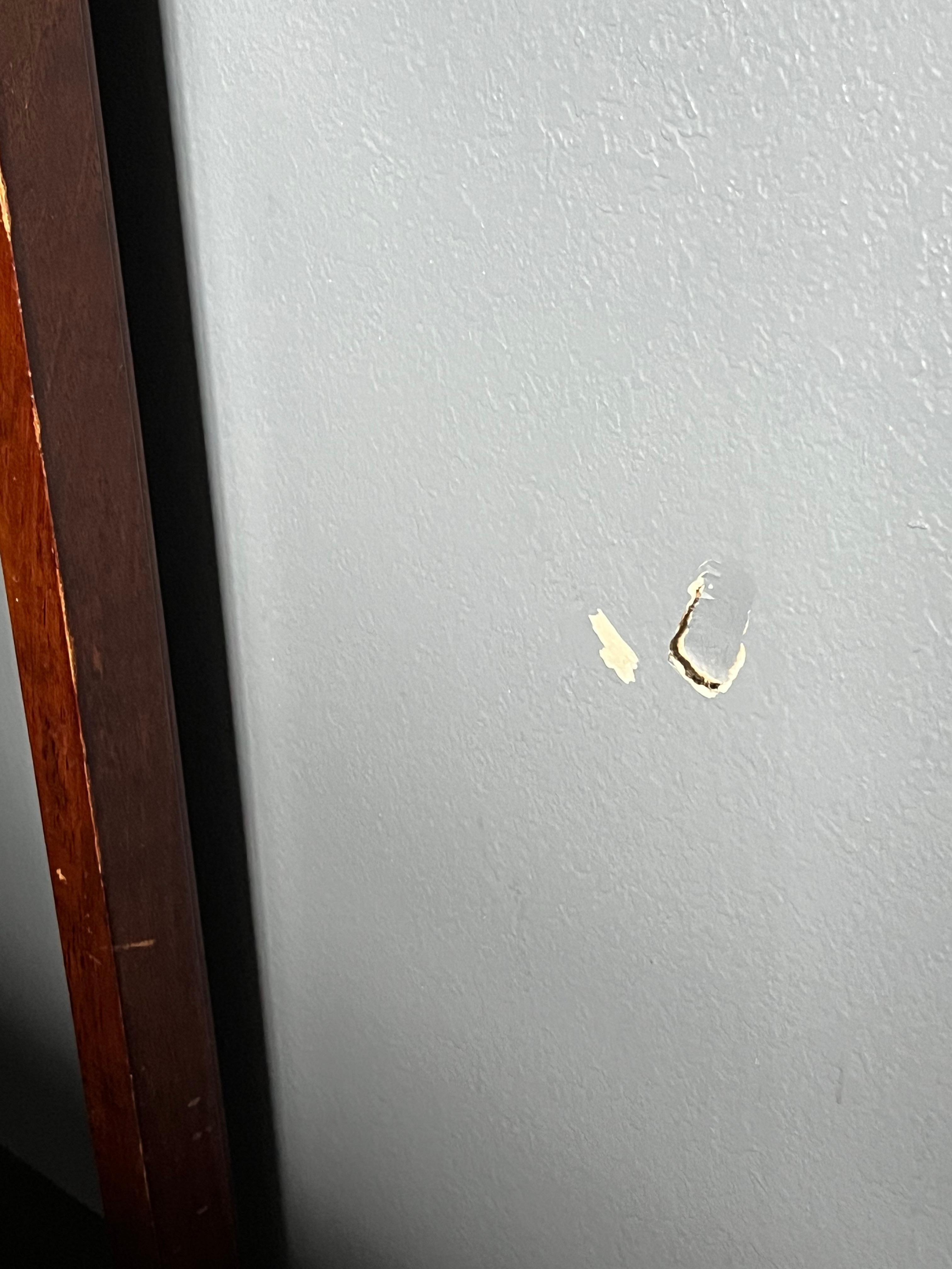 Hole in wall next to bed