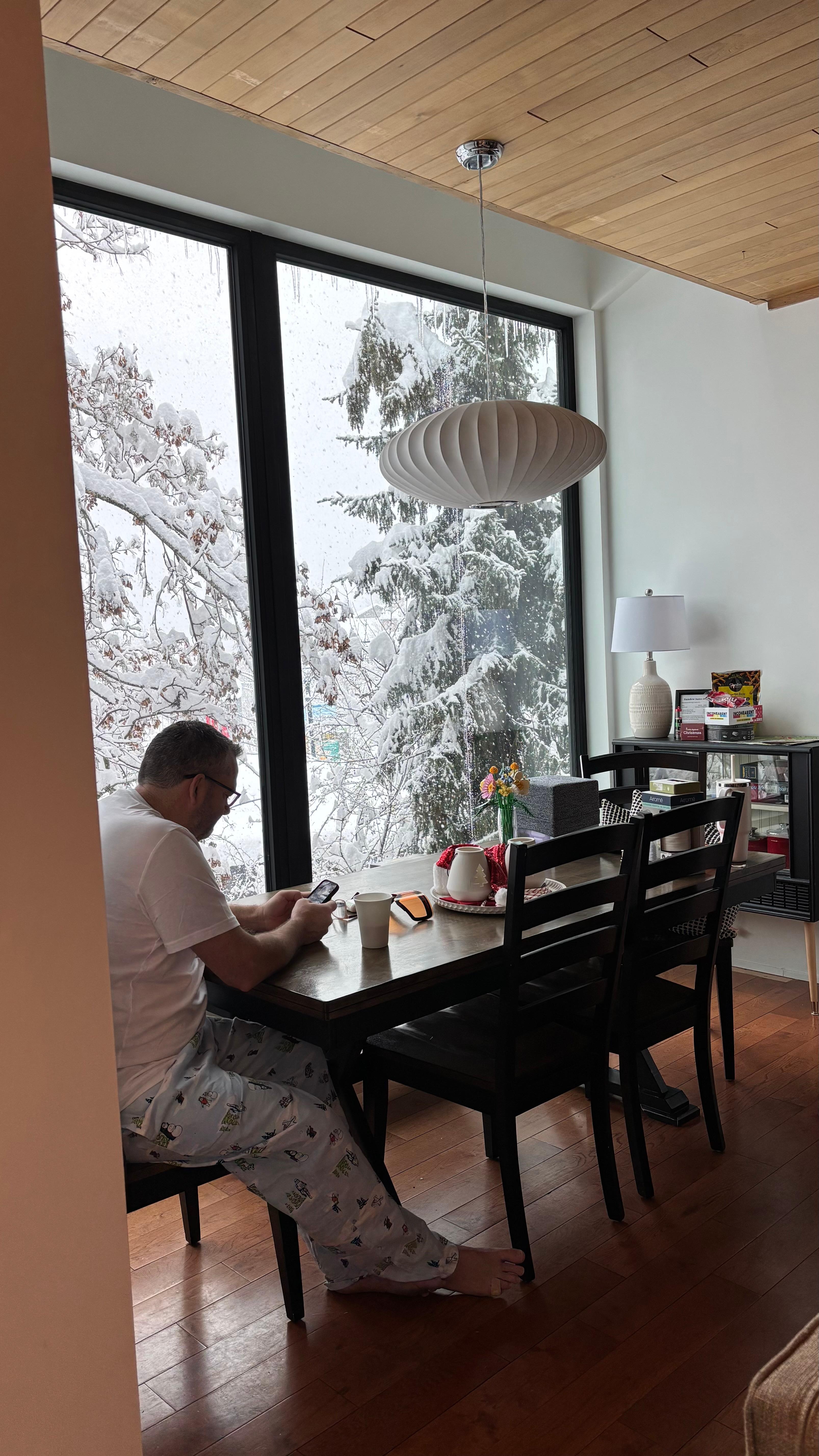 Enjoying coffee at the table while it snows. 