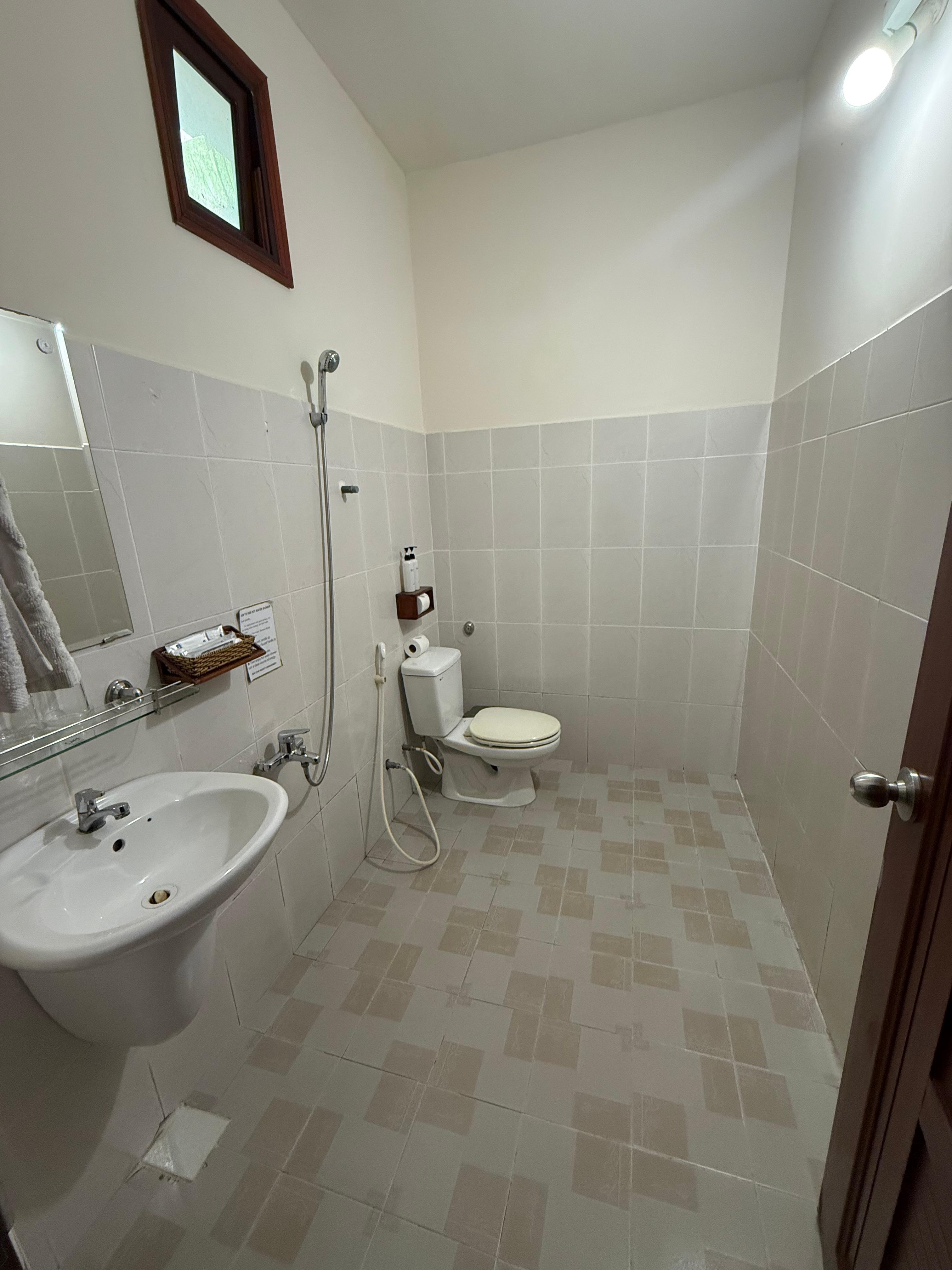 Bathroom is standard SE Asian water room. 