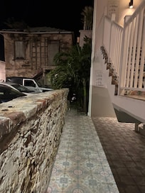 Dark pathway with parking lot with construction site and loading area (maybe)