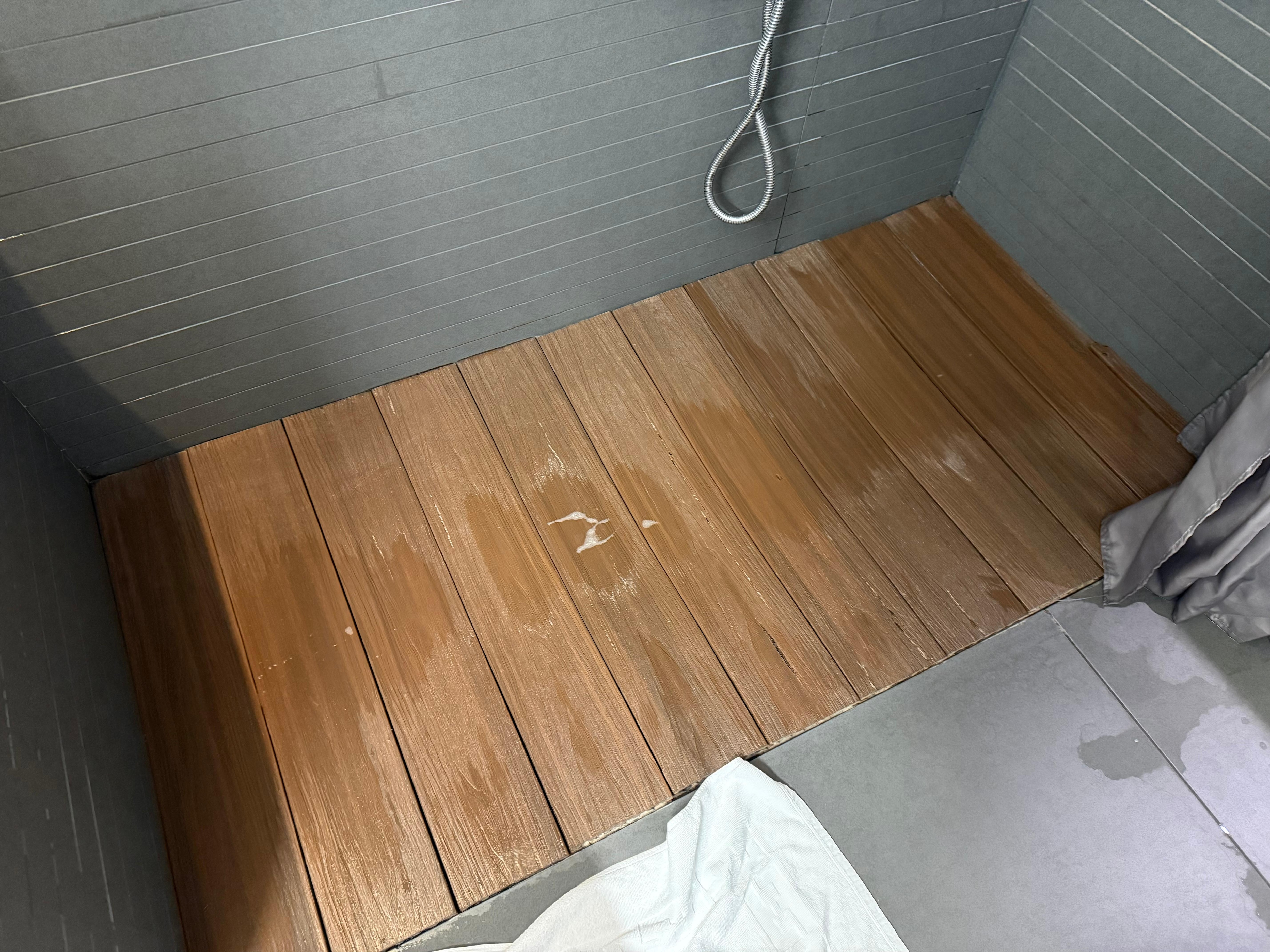Wooden shower deck that sinks when you step on it