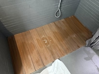Wooden shower deck that sinks when you step on it