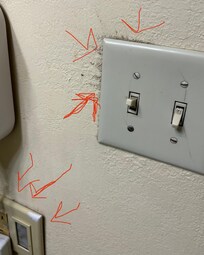 Mold growing around switch plate close to other electrical outlet.