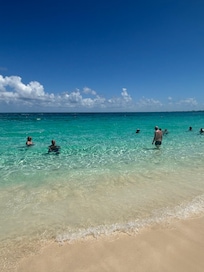 Water at the beach, so clear you could see fish swimming around you.